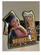 Load image into Gallery viewer, Graduation-themed cutout with a photo of a graduate and text celebrating Bethel High School's Class of 2025.
